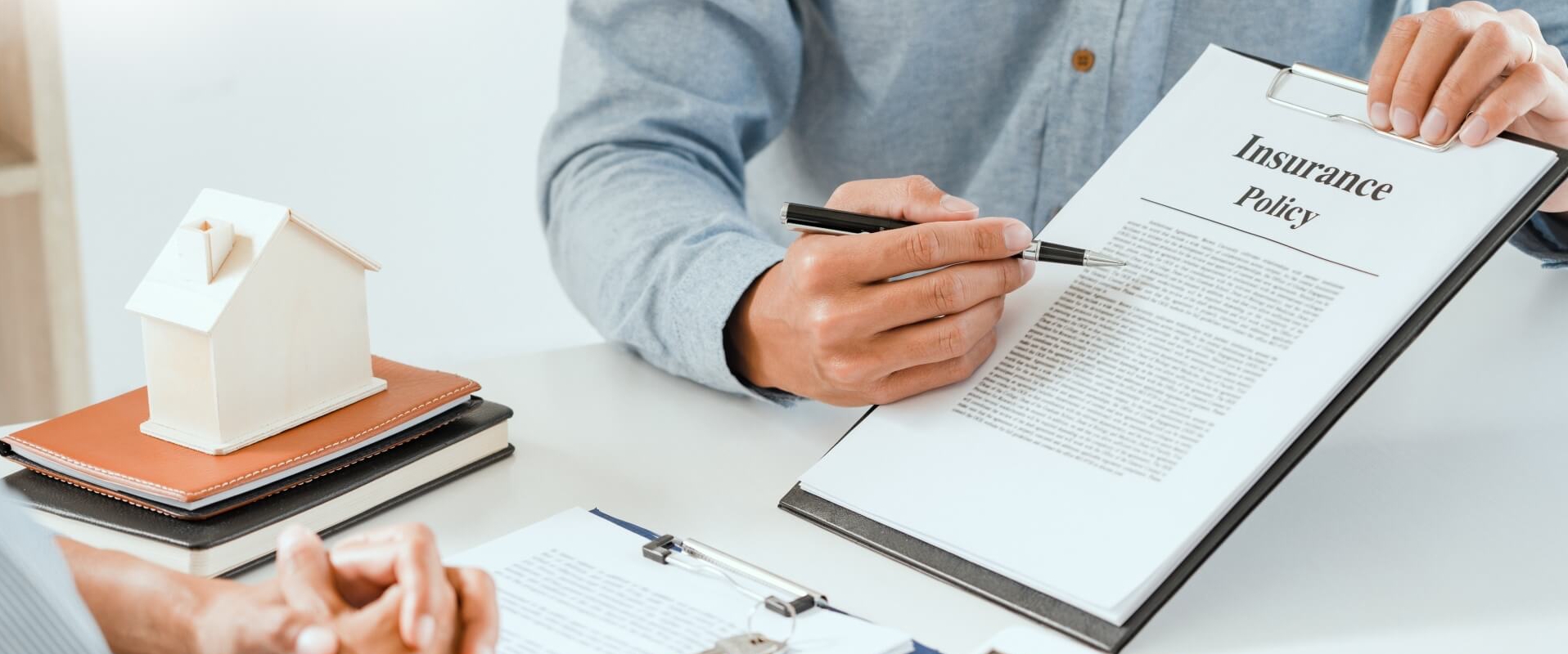 Real estate agent explaining insurance policy to customer